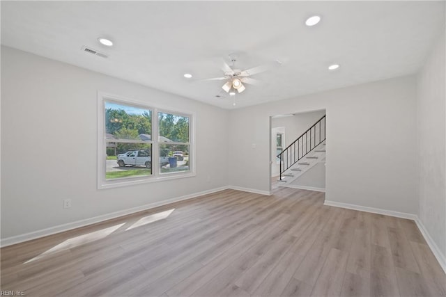 empty room with light wood-type flooring and ceiling fan