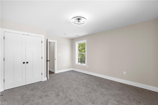 unfurnished bedroom featuring carpet flooring and a closet