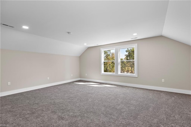 additional living space with carpet and vaulted ceiling