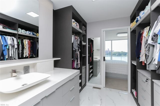 walk in closet featuring sink