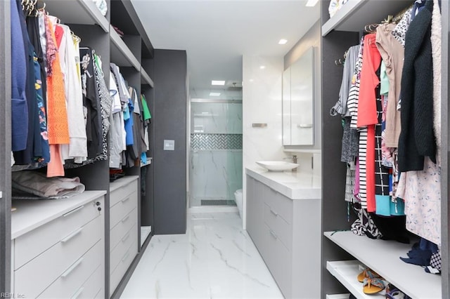 walk in closet featuring sink