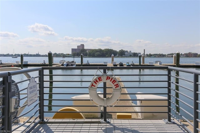 exterior space featuring a balcony and a water view