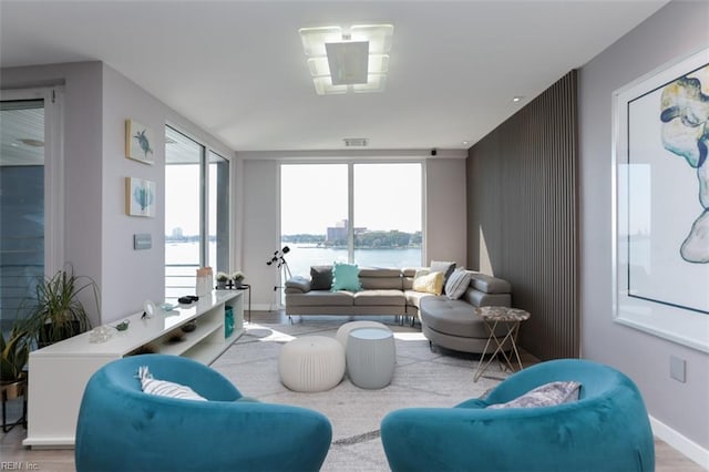 living room featuring hardwood / wood-style floors and a water view