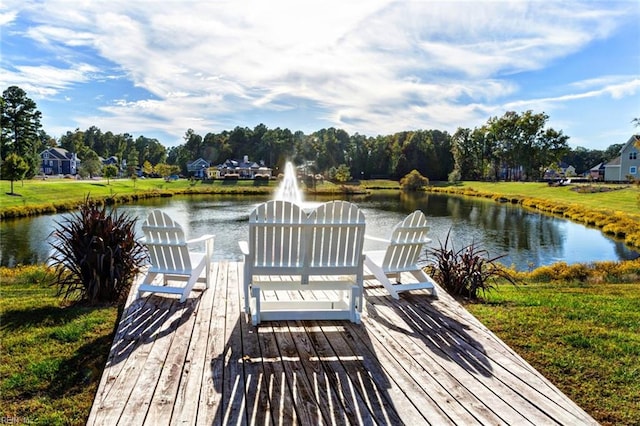 dock area featuring a lawn and a water view