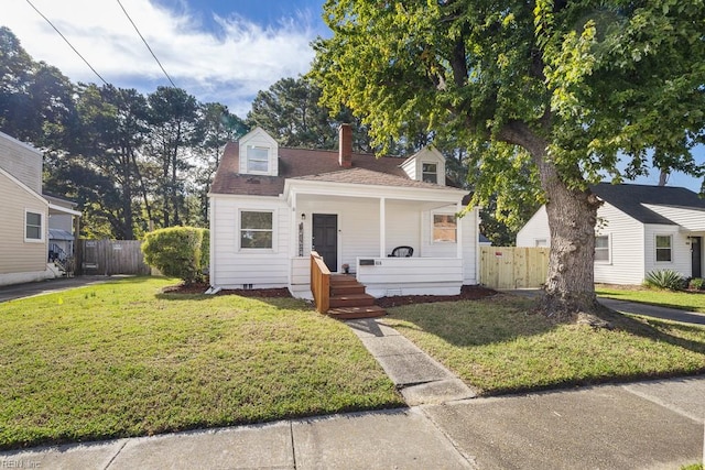 view of front of house with covered porch and a front yard