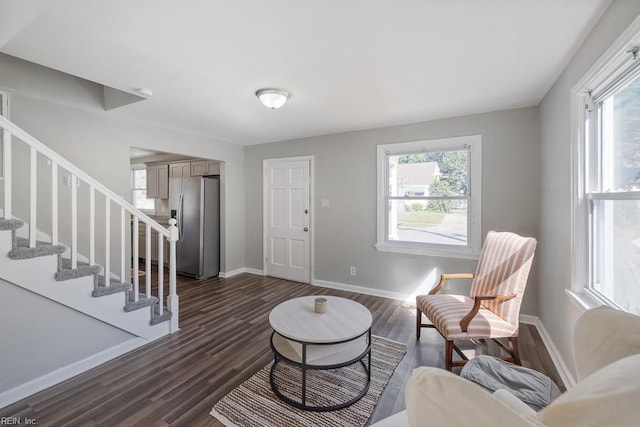 living area featuring dark wood-type flooring and plenty of natural light