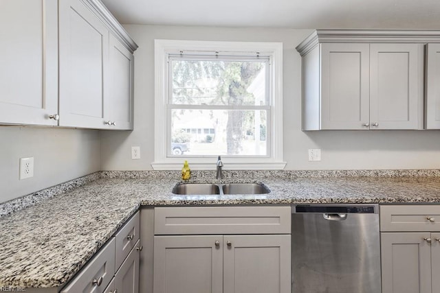 kitchen featuring gray cabinetry, light stone countertops, sink, and dishwasher