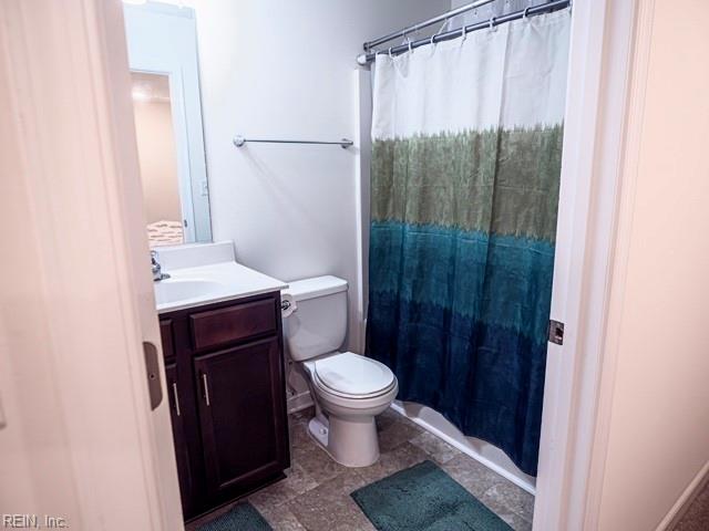 bathroom with vanity, toilet, and a shower with shower curtain