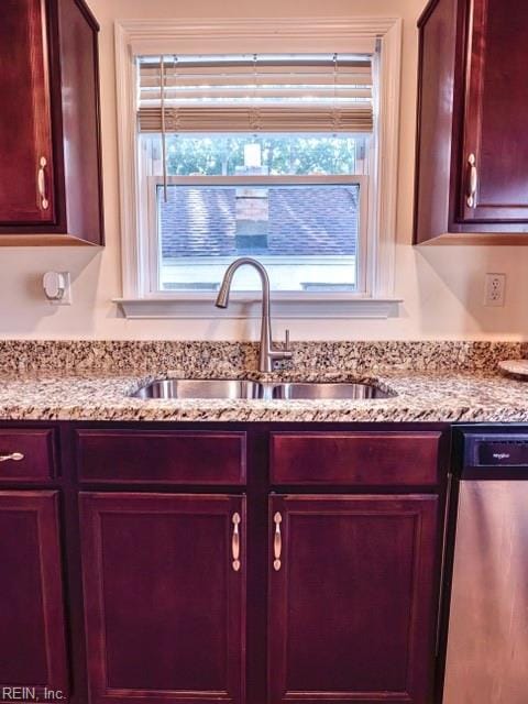 details with light stone counters, sink, and dishwasher