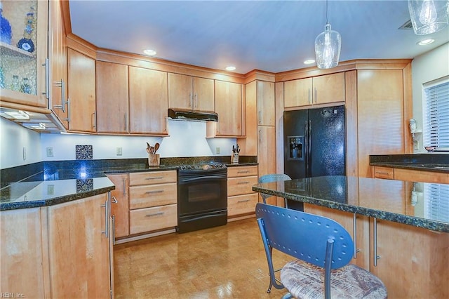 kitchen featuring dark stone counters, decorative light fixtures, and black appliances