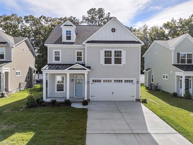 view of front of home featuring a front yard, a garage, and central AC