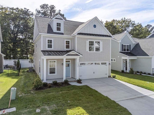 view of front facade featuring a front yard, a garage, and central AC unit