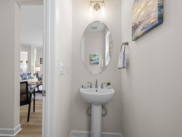 bathroom with hardwood / wood-style floors