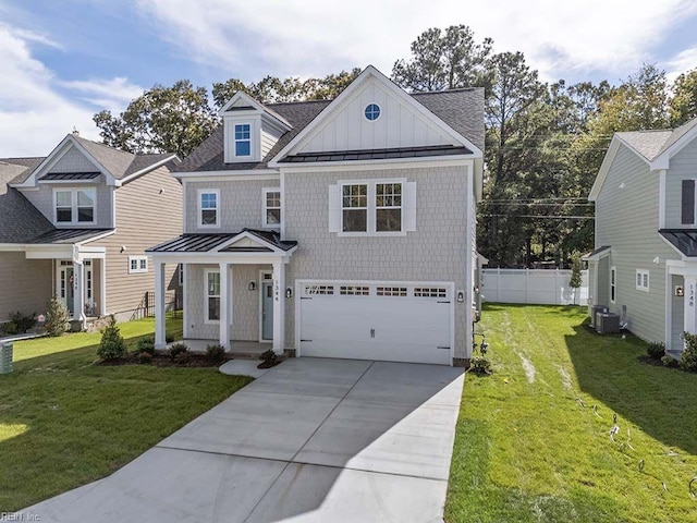 view of front facade featuring a garage, a front yard, and central AC unit