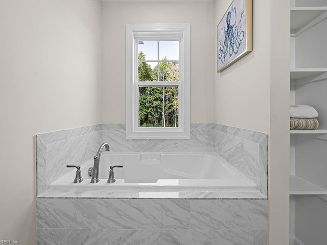 bathroom featuring tiled tub