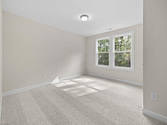 unfurnished room with light carpet