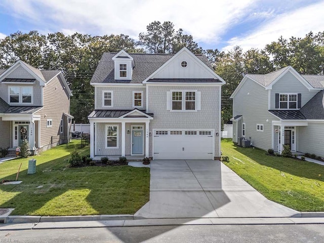 view of front of property featuring a garage, a front yard, and central AC