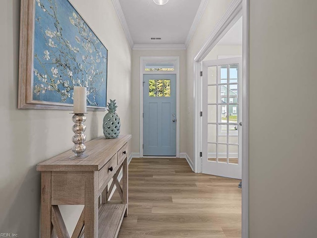 doorway with light wood-type flooring and crown molding