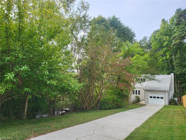 view of front of house featuring a garage and a front lawn