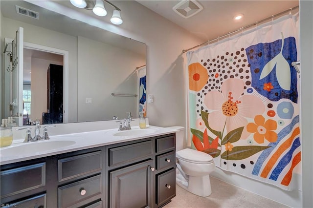 bathroom featuring vanity, walk in shower, and toilet