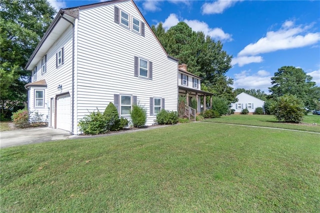 view of side of home with a yard and a garage