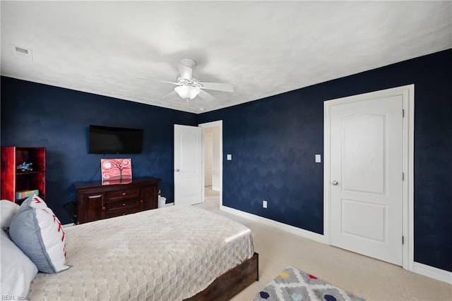 bedroom featuring ceiling fan and carpet