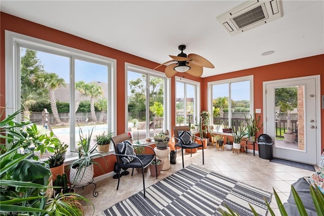 sunroom / solarium featuring ceiling fan