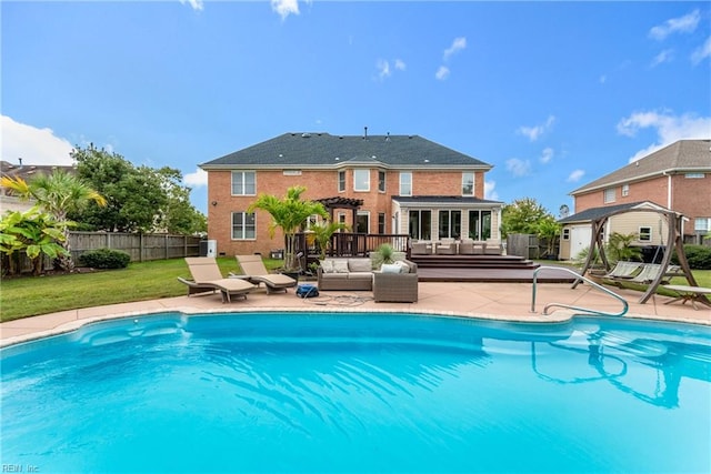 view of swimming pool featuring an outdoor living space, a lawn, and a patio area