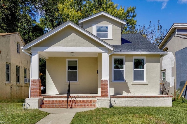 view of front of home featuring a front lawn and cooling unit