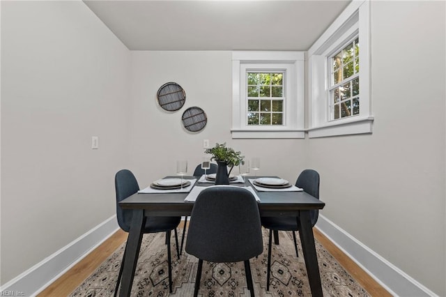 dining space with hardwood / wood-style floors