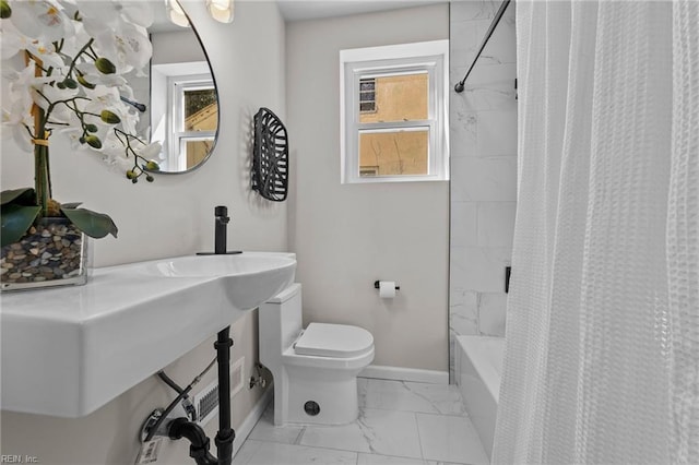 bathroom featuring shower / bathtub combination with curtain and toilet