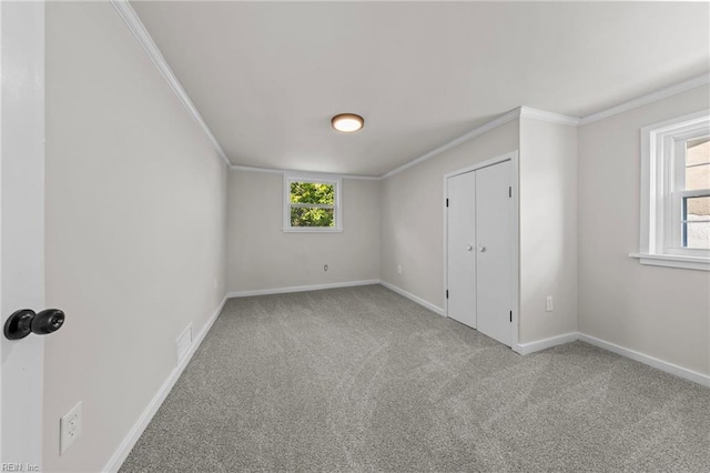 unfurnished bedroom featuring crown molding and light colored carpet