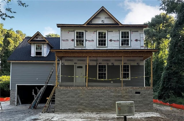 property under construction featuring a porch and a garage