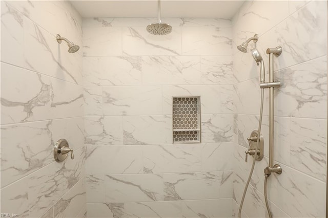 bathroom with tiled shower