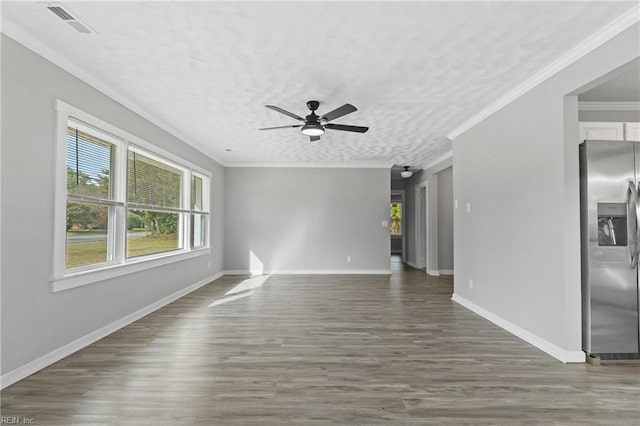 unfurnished living room with dark wood-type flooring, ceiling fan, ornamental molding, and a textured ceiling