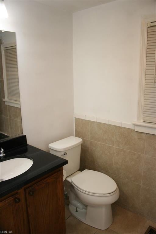 bathroom with vanity, tile walls, toilet, and tile patterned floors