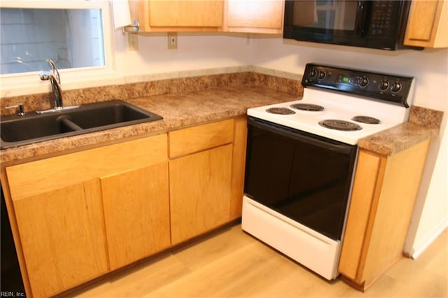 kitchen with light hardwood / wood-style flooring, electric stove, and sink