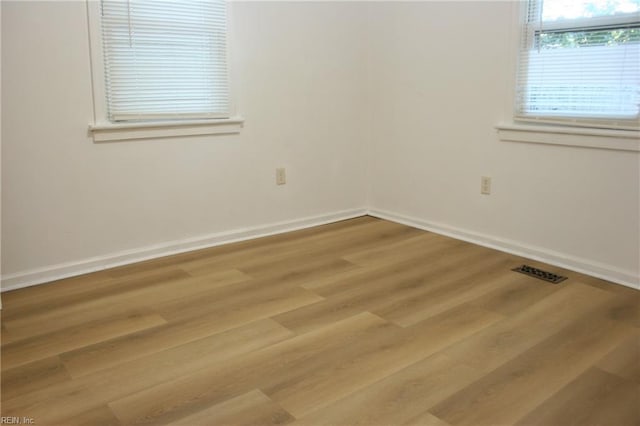 spare room featuring light hardwood / wood-style floors