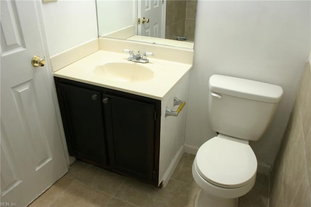 bathroom with tile patterned flooring, vanity, and toilet