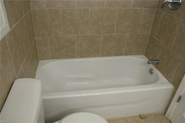 bathroom with tile patterned flooring and toilet