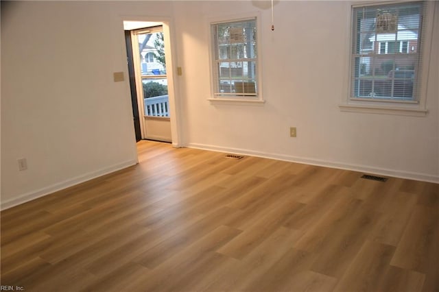 empty room with hardwood / wood-style floors