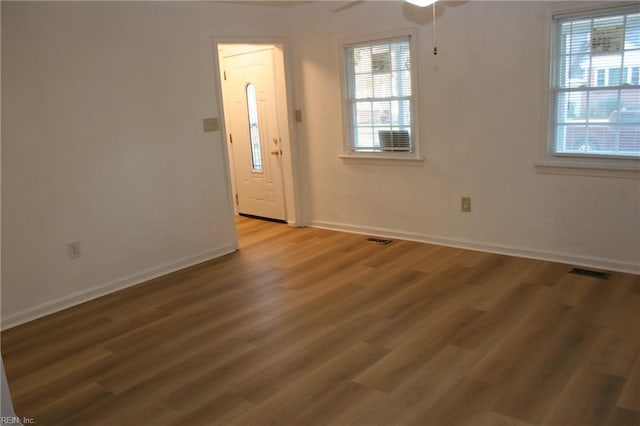 foyer with ceiling fan and dark hardwood / wood-style flooring