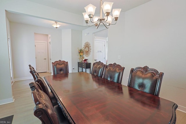 dining space featuring a chandelier and light hardwood / wood-style floors