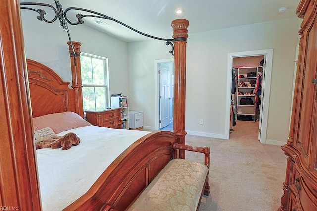 carpeted bedroom with a closet and a walk in closet