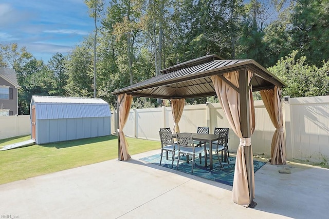 view of patio / terrace with a gazebo and a storage unit