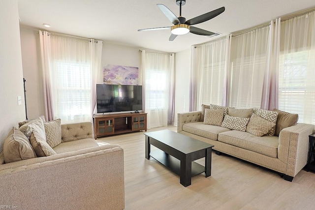 living room featuring ceiling fan and light hardwood / wood-style flooring