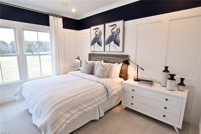 carpeted bedroom featuring crown molding and ceiling fan