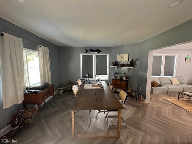 dining space featuring parquet floors