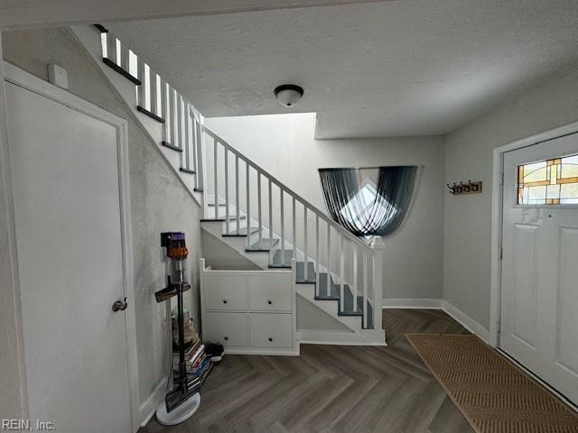 entryway featuring dark parquet flooring