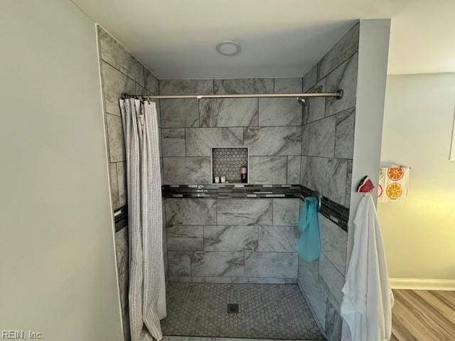 bathroom featuring hardwood / wood-style flooring and curtained shower